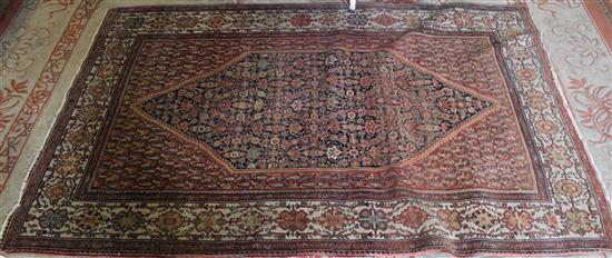 Persian rug with blue field, red boteh filled spandrels and ivory guards